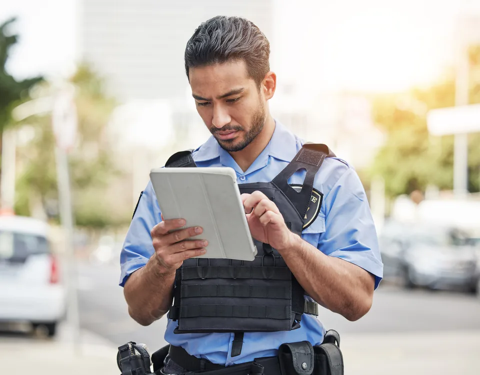 Uniformed field user working on a tablet outdoors